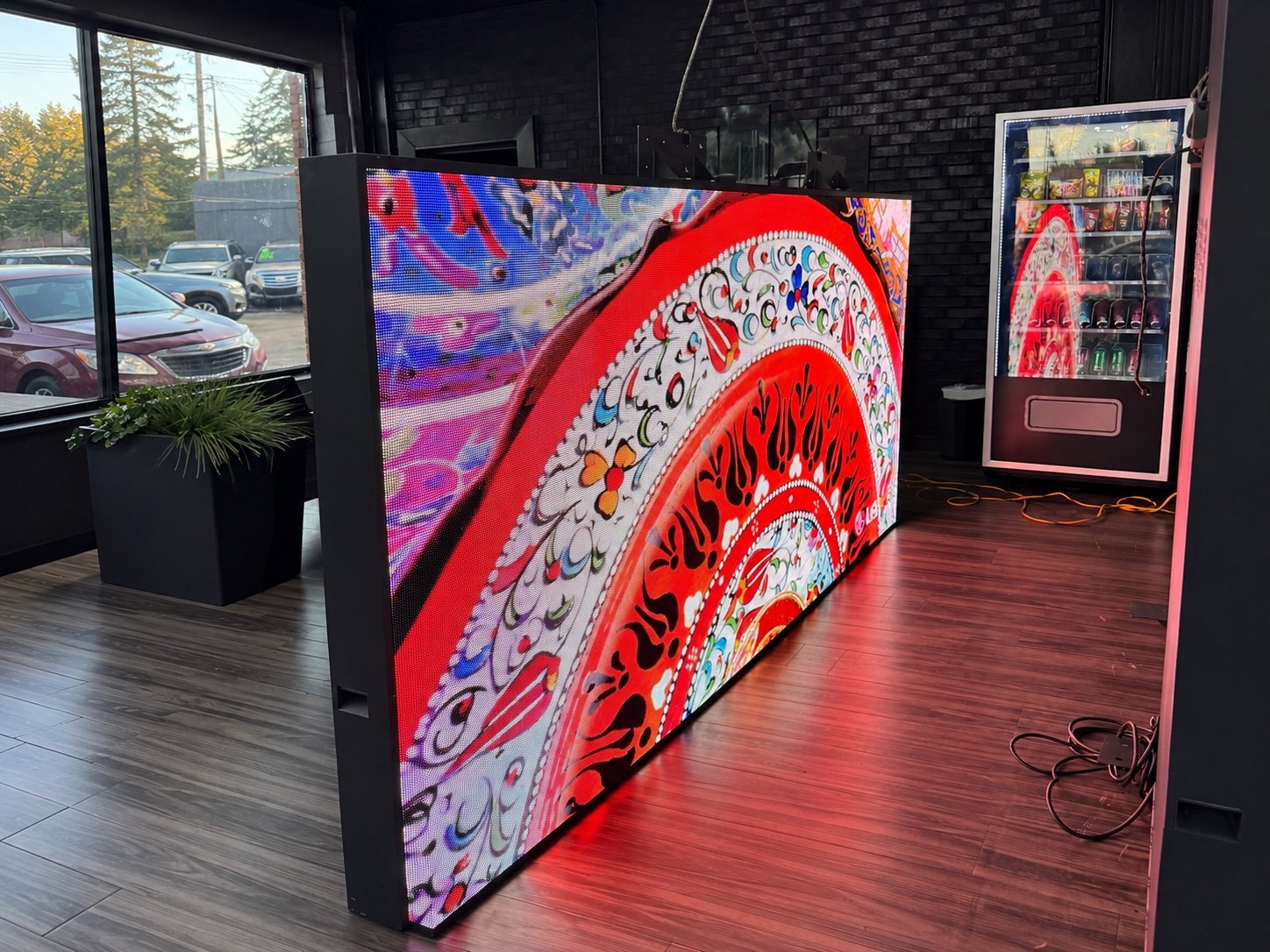 Angled view of the Greenfield Motors indoor LED display during content testing