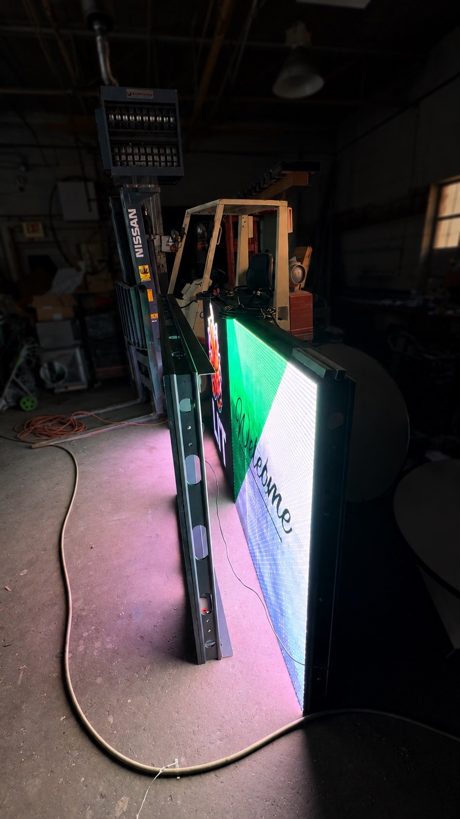 Side view of the New Buffalo monument sign during digital LED screen testing in the PixaClear LED shop