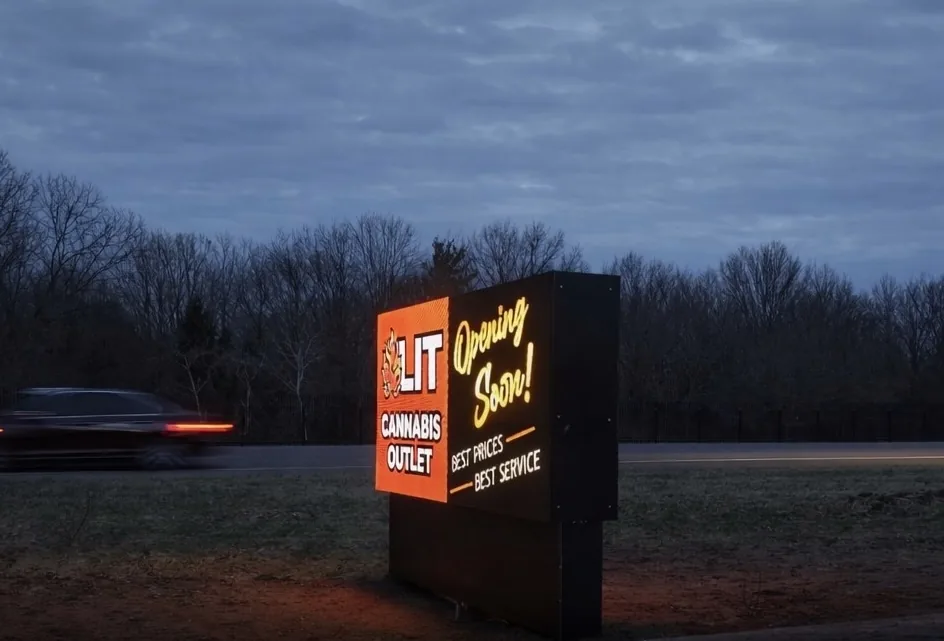 New Buffalo digital LED monument sign illuminated at night beside passing traffic