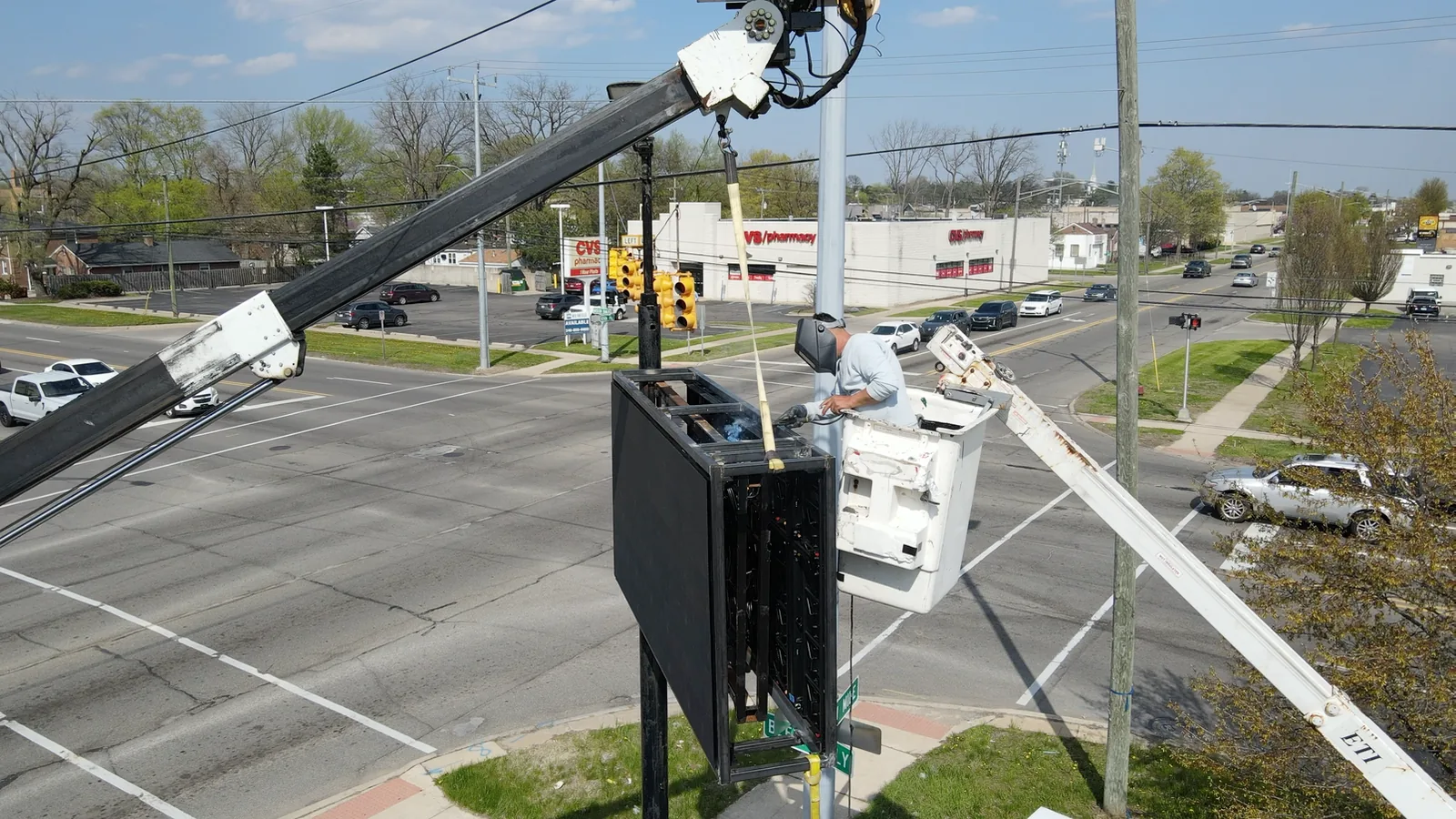 PixaClear LED technician working from a lift on an outdoor LED pole sign installation in Redford, Michigan