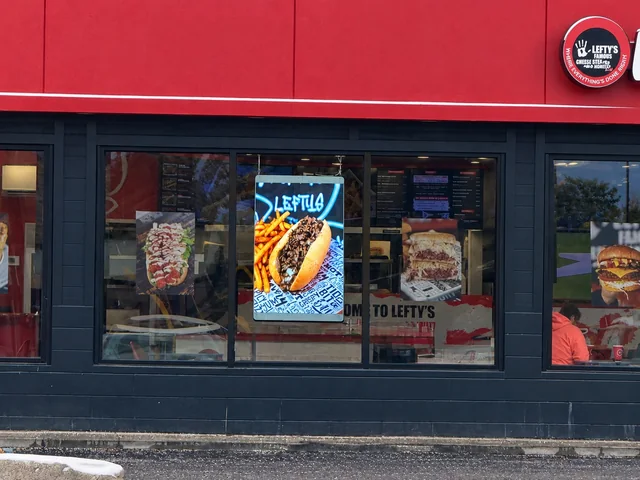 Transparent LED poster advertising in Lefty's Livonia storefront